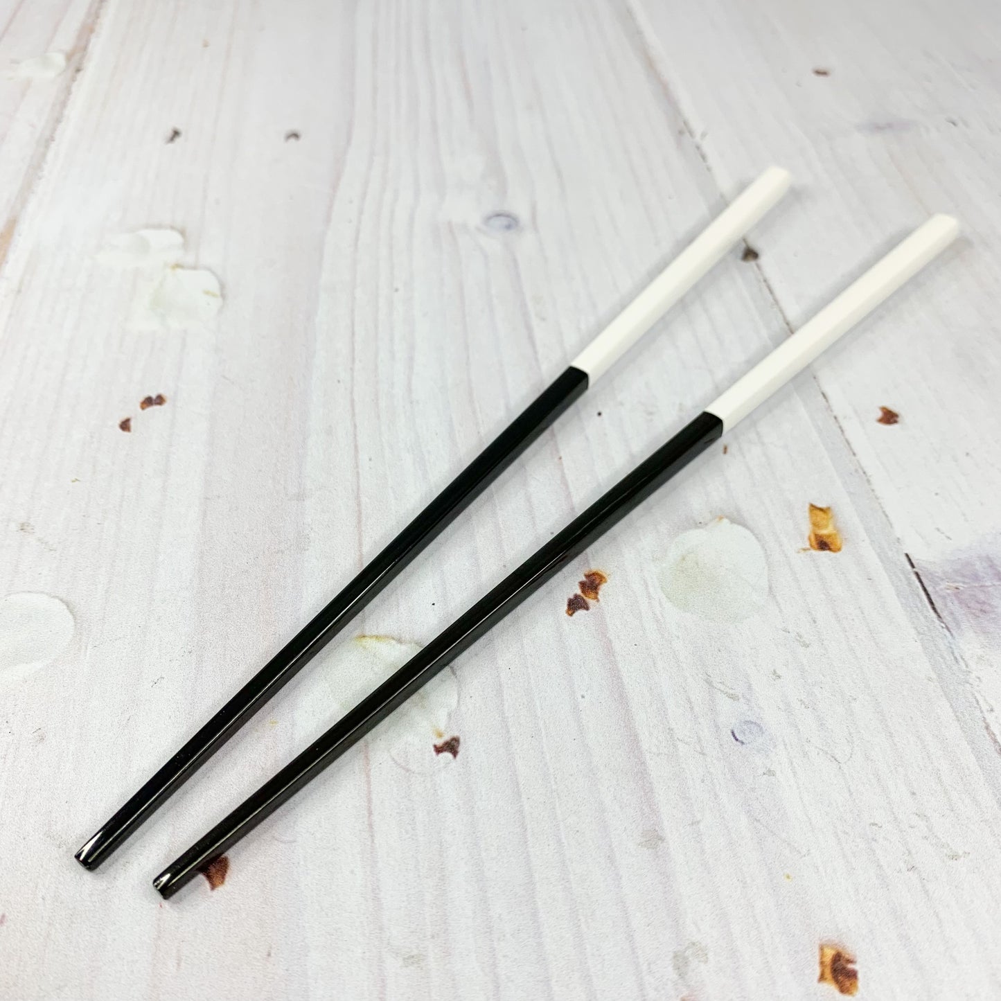 Par de palillos negros con blanco (acero inoxidable)
